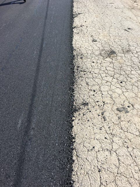 Asphalt driveway repair in progress by Marvel Grading & Paving