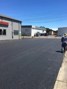 An asphalt road near shops