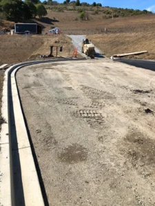 A concrete road near a hill