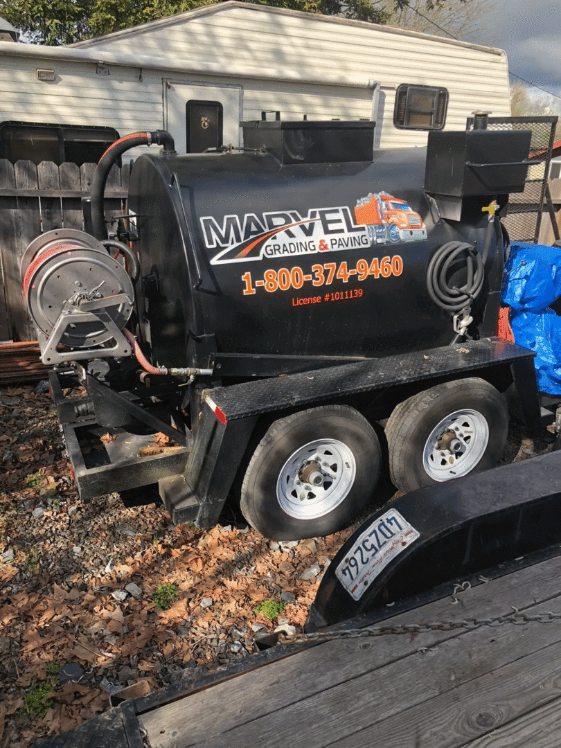 A black Marvel branded trailer-mounted machine with hoses and equipment.